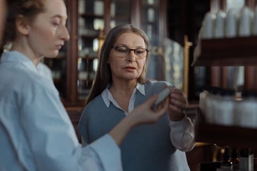 A pharmacist helping a customer at a pharmacy counter